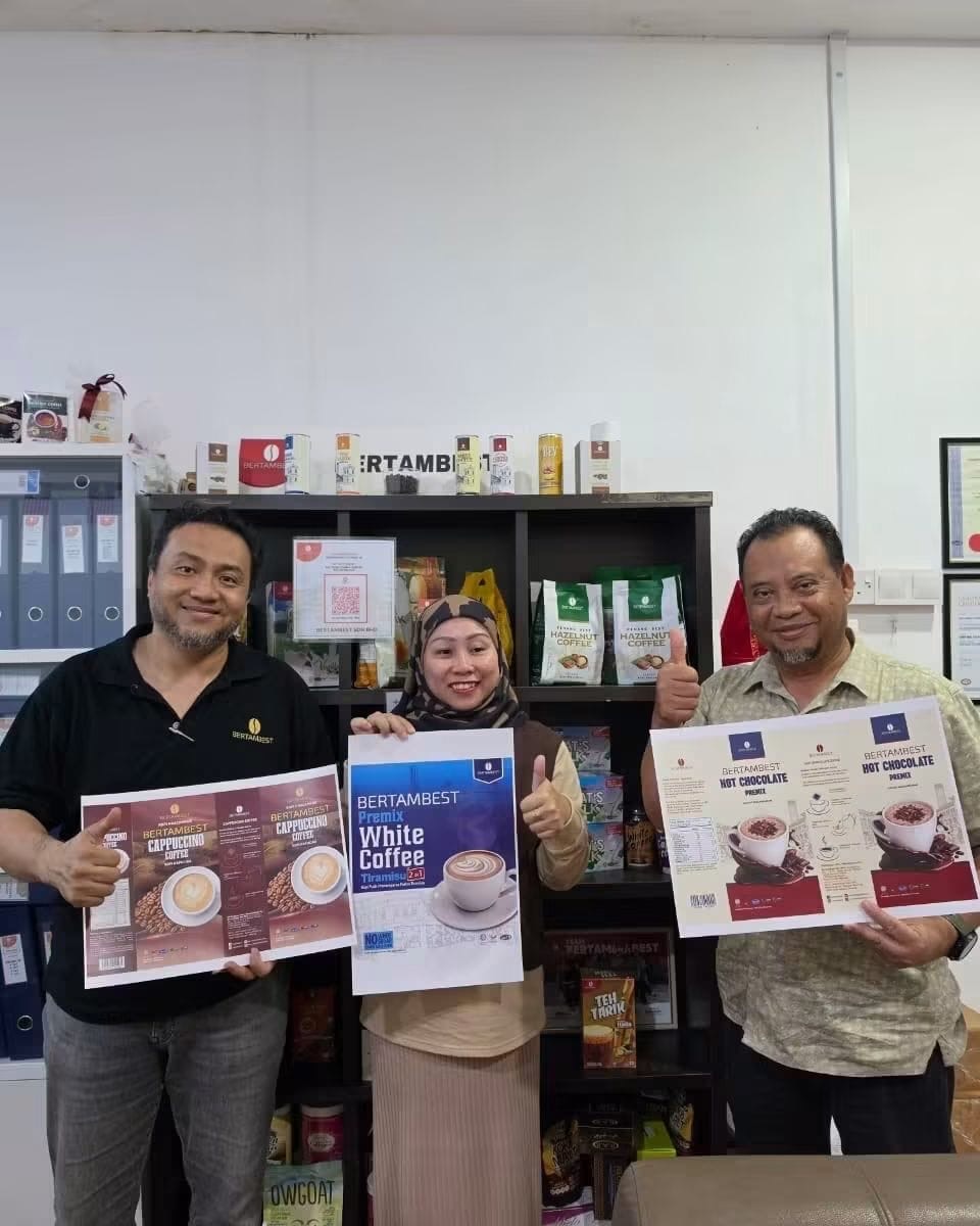 BERTAMBEST team holding product posters to celebrate entering the Cambodian market